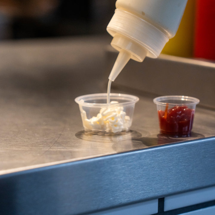 Packaging Wise 2oz clear PET sauce pot — small portion cup ideal for mayonnaise, dips, and condiments, perfect for cafes, takeaways, and food trucks.